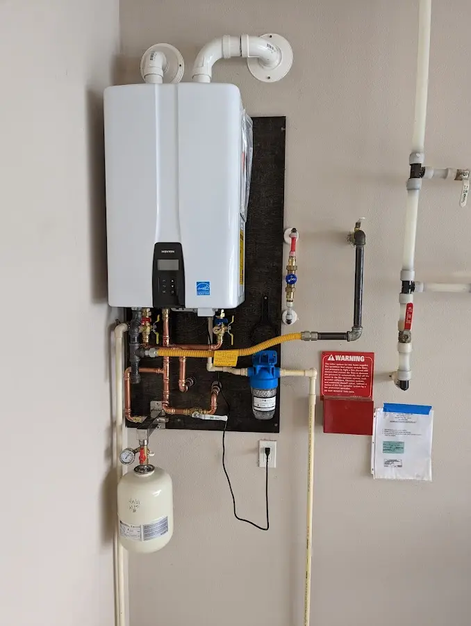 Professional plumber installing copper piping in a Buckingham home